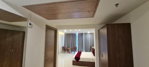 a room with a bedroom with a bed and a mirror at Pearl Palace in Attingal