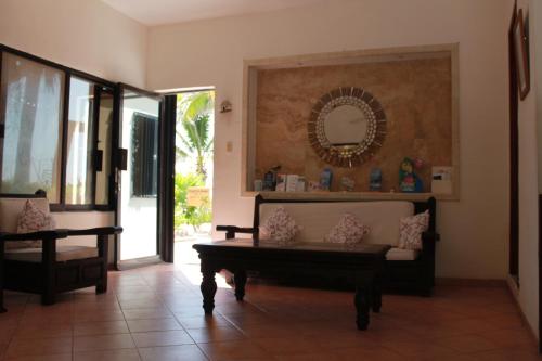 a living room with a couch and a mirror at Hotel Villa Kiin in Isla Mujeres