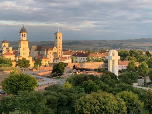 a view of a town with two towers and trees at Citadel Residence in Alba Iulia