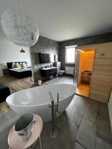 a bathroom with a large white tub in a room at RingLodge in Kelberg