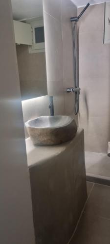 a bathroom with a stone sink on a counter at Guru accommodations in Mýkonos City