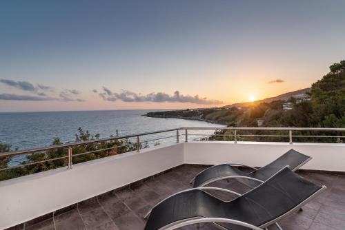 a view of the ocean from the balcony of a house at Porto Belissario in Ferma