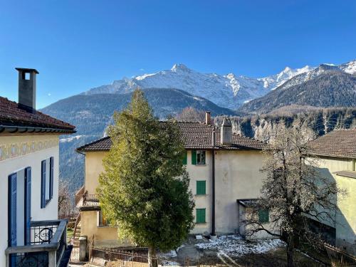 a group of buildings with mountains in the background at Casa Bella Oschesina by Quokka 360 - in the village of Osco in Osco
