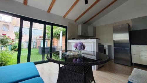 a living room with a table and a kitchen at Villa AYA - with sauna and outdoor swimming pool in Mostar