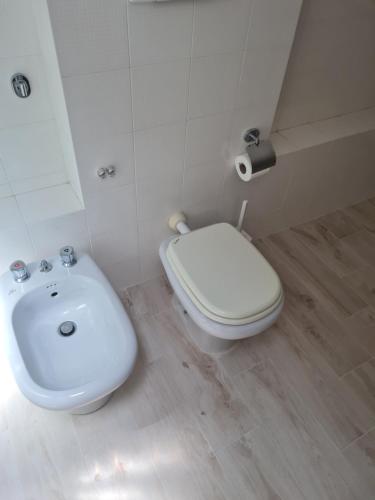 a bathroom with a white toilet and a sink at B&B Soverato Centro in Soverato Marina