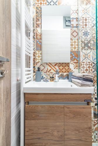 a bathroom with a sink and a mirror at Villa Lydia in Rethymno