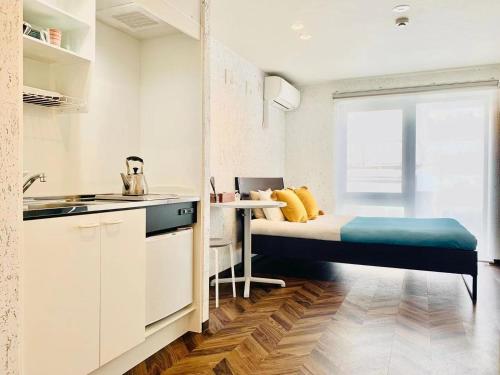 a small apartment with a bed and a kitchen at TIME SHARING STAY Ikebukuro in Tokyo