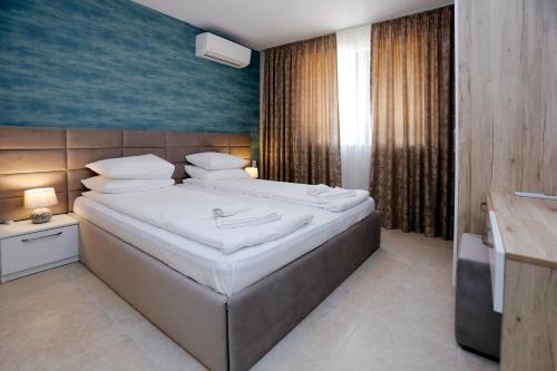 a bedroom with a large bed in a room at Green Life Apartments Sozopol in Sozopol
