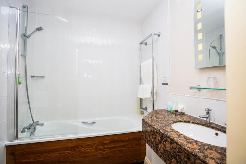 a bathroom with a sink and a shower at The Moat House in Stafford