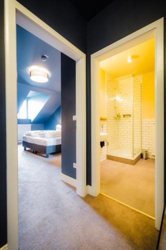 a room with a bathroom with a bed and a shower at Hotel Luis in Regensburg