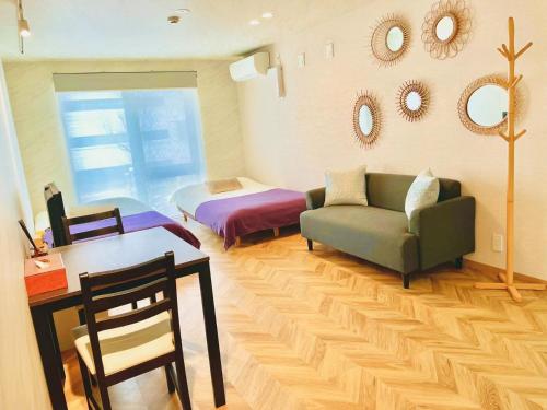 a living room with a couch and a bed at TIME SHARING STAY Ikebukuro in Tokyo
