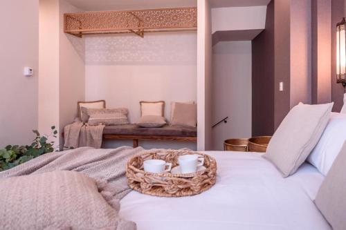 a room with a bed with a basket on it at CANDIL SUITE Origen in Granada