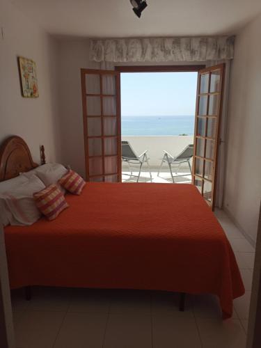 um quarto com uma cama e vista para o oceano em Rayos de Sol em Peníscola