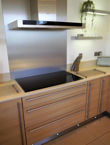 a kitchen with a sink and a stove top oven at Annapurna in Portpatrick