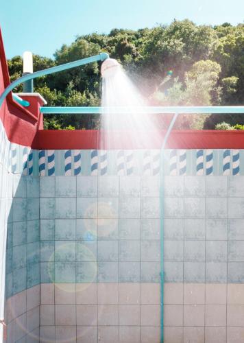 a person spraying a pool with a water hose at Summer Dream Hotel in Polykhrono