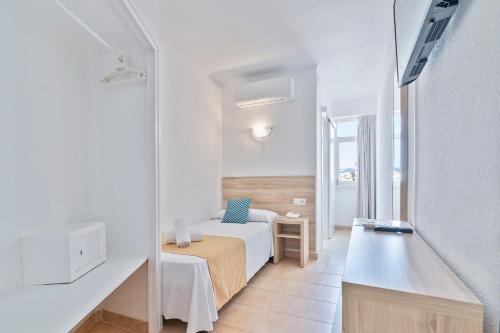 a hotel room with a bed and a desk at Suncoast Ibiza Hotel - Adults Only - in Ibiza Town