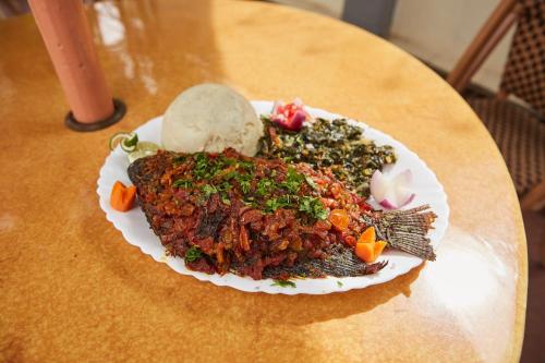 a plate of food on top of a table at Dunga LakeSide Resort in Kisumu