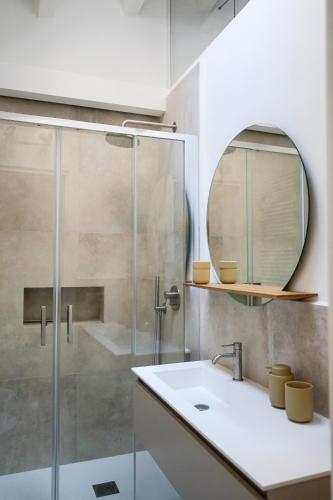 a bathroom with a shower and a sink and a mirror at Casa Chiara in Cefalù