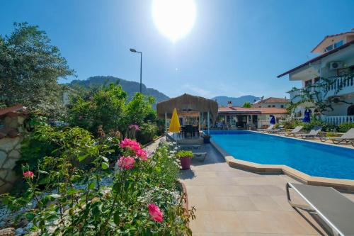 a swimming pool in a resort with flowers at Casablanca Hotel in Dalyan