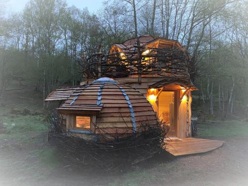 a small tree house with lights on top of it at Les Cabanes De Pyrene in Cazarilh