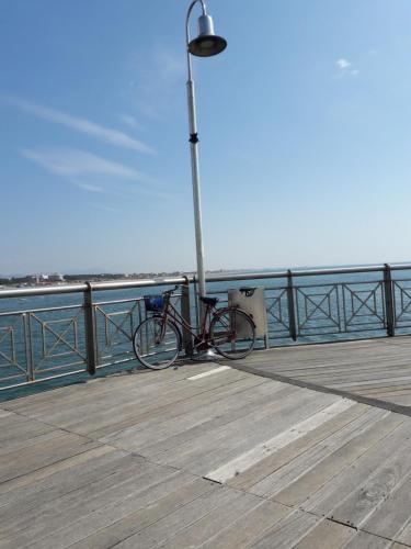 a bike parked next to a light pole on a pier at Art Hotel Pietrasanta in Pietrasanta