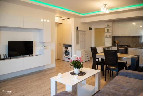 a living room with a kitchen and a dining room at SARA Moonlight Residence in Mamaia