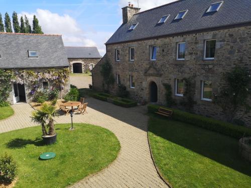 an aerial view of a large stone building with a courtyard at Maison de Yec'hed mat, authentique et charmante. in Pommerit-Jaudy