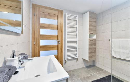 a white bathroom with a sink and a shower at Beautiful Home In Stubicke Toplice in Stubicke Toplice