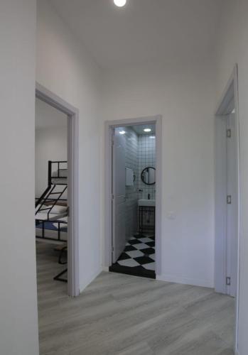 an empty room with a hallway with a door open at Polifonia Inn Borjomi in Borjomi
