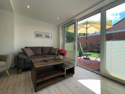 a living room with a couch and a table at Marions Apartments Greetsiel in Greetsiel