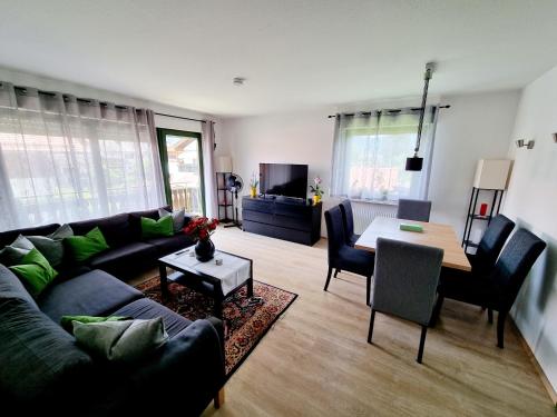 a living room with a couch and a table at Ferienwohnung Staufenblick in Piding