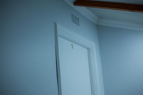 a room with a large window and a blue wall at Kv Luxury Guest House in Johannesburg