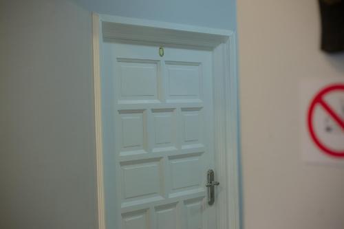 a white door with a clock next to it at Kv Luxury Guest House in Johannesburg