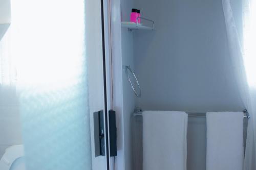 a bathroom with a shower with a glass door at Kv Luxury Guest House in Johannesburg