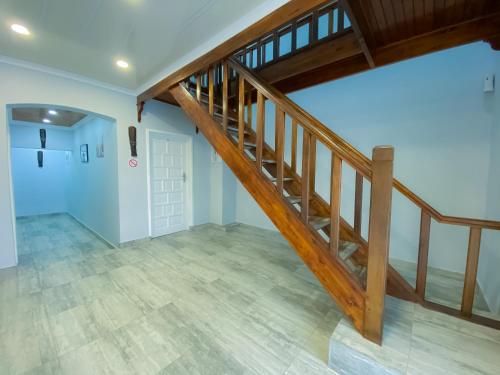 an empty room with a wooden staircase in a house at Kv Luxury Guest House in Johannesburg