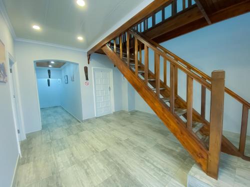 an empty hallway with a wooden staircase in a house at Kv Luxury Guest House in Johannesburg