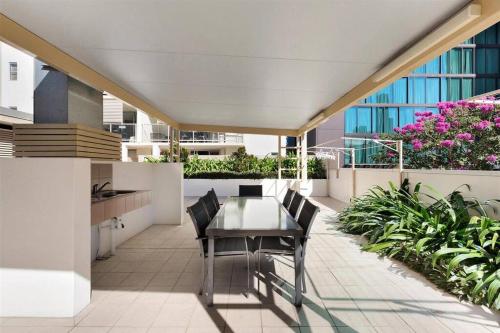 a balcony with a table and chairs on a building at Merivale stay in South Brisbane two beds two baths one parking in Brisbane