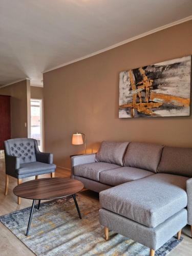 a living room with a couch and a table at Island Club by Smart City Stays in Cape Town