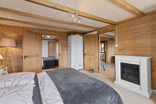 a bedroom with a bed and a fireplace at App. Seeblick Top of Interlaken in Beatenberg
