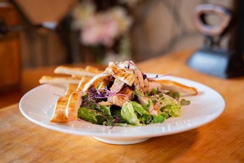 a plate of food with a salad and french fries at Penzion a restaurace Staré Časy in Horní Bečva