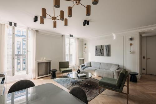 a living room with a couch and a table at HIGHSTAY - Luxury Serviced Apartments - Louvre-Rivoli in Paris