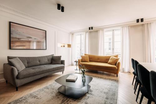 un salon avec deux canapés et une table basse dans l'établissement HIGHSTAY - Luxury Serviced Apartments - Place Vendôme, à Paris