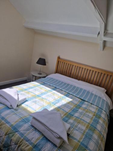 a bedroom with a bed with towels on it at Church View at Plover Cottage Lindley in Huddersfield