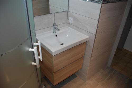 a bathroom with a white sink and a shower at Bel appart saint clair-lavandou in Le Lavandou