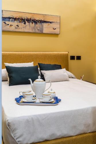 a tray with a tea set on a bed at De Gulia Charme and Relax in Castellabate