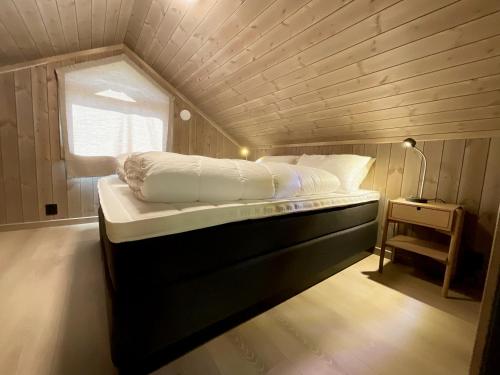 a bedroom with a bed in a tiny house at Haukland Beach View - Superior cabin in Leknes