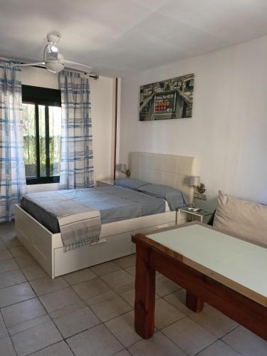 a bedroom with two beds and a couch at SERVILUx 2 in Torremolinos