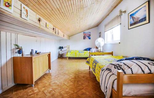 a bedroom with a bed and a dresser in it at Amazing Apartment In Otok Ist With Wifi And 2 Bedrooms in Ist