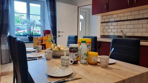 a wooden table with food on it in a kitchen at Le Gai Pinson in Beausaint