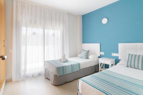 Postel nebo postele na pokoji v ubytování IBERSOL SPA AQQUARIA SUITES